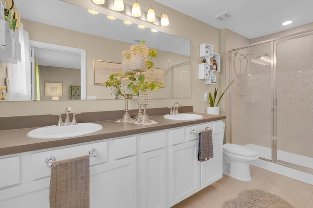 316 Primrose Dr, Davenport, FL 33837 - full bath featuring toilet, a shower stall, tile patterned flooring, and double vanity