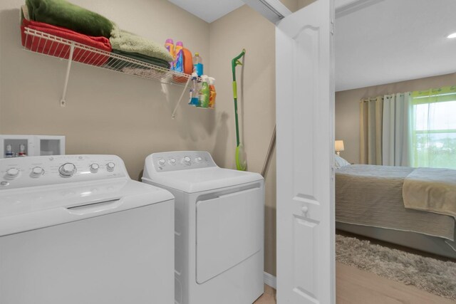 316 Primrose Dr, Davenport, FL 33837 - laundry area featuring washing machine and clothes dryer and light wood-style floors