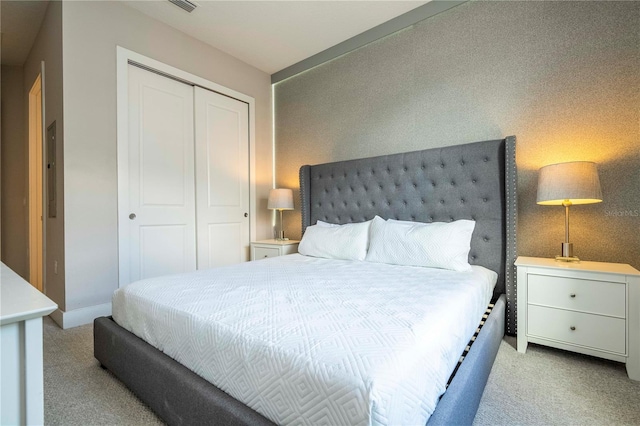 bedroom with carpet floors, a closet, and baseboards