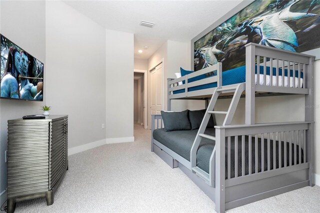 carpeted bedroom featuring baseboards and recessed lighting