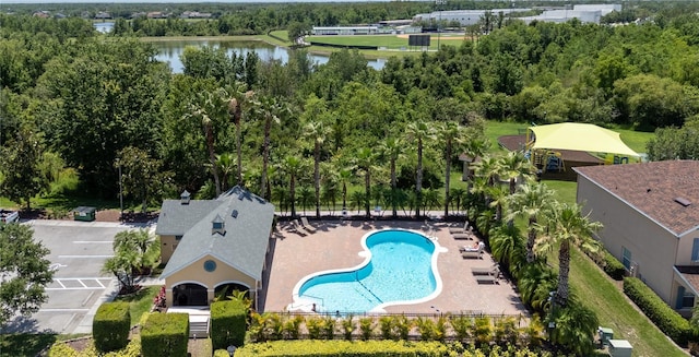 aerial view of a pool area and a nearby body of water
