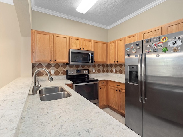 kitchen with appliances with stainless steel finishes, a sink, tasteful backsplash, a textured ceiling, and crown molding