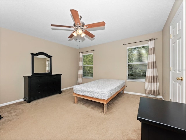 bedroom with baseboards and multiple windows