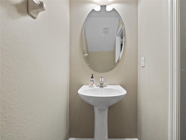 bathroom featuring a textured wall