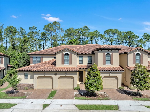 8215 Roseville Blvd, Davenport, FL 33896 - mediterranean / spanish home featuring stucco siding, decorative driveway, and a tiled roof