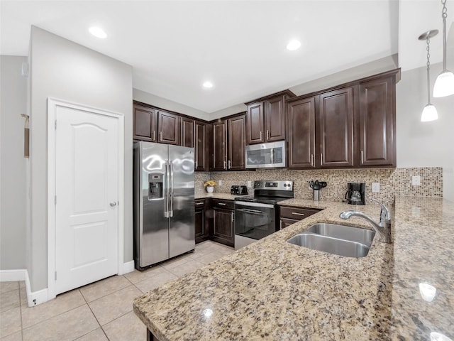8215 Roseville Blvd, Davenport, FL 33896 - kitchen with stainless steel appliances, a sink, dark brown cabinetry, light stone countertops, and light tile patterned floors