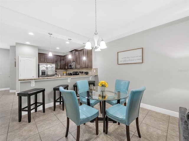 8215 Roseville Blvd, Davenport, FL 33896 - dining area with light tile patterned floors, baseboards, recessed lighting, and a chandelier