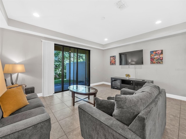 8215 Roseville Blvd, Davenport, FL 33896 - living room featuring baseboards, light tile patterned flooring, a raised ceiling, and recessed lighting