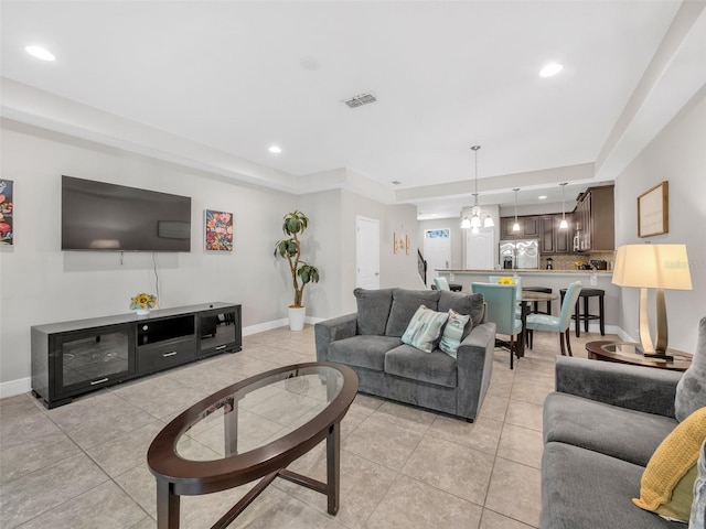 8215 Roseville Blvd, Davenport, FL 33896 - living area featuring light tile patterned floors, a tray ceiling, baseboards, recessed lighting, and a chandelier