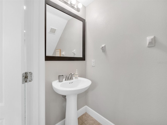 8215 Roseville Blvd, Davenport, FL 33896 - bathroom with baseboards, tile patterned flooring, and a sink