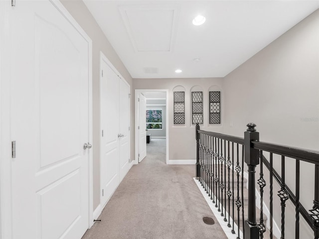 8215 Roseville Blvd, Davenport, FL 33896 - hall featuring light colored carpet, baseboards, attic access, recessed lighting, and an upstairs landing