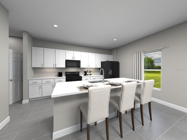 16466 Silver Brook Way, Winter Garden, FL 34787 - kitchen with black appliances, a sink, an island with sink, light countertops, and a breakfast bar