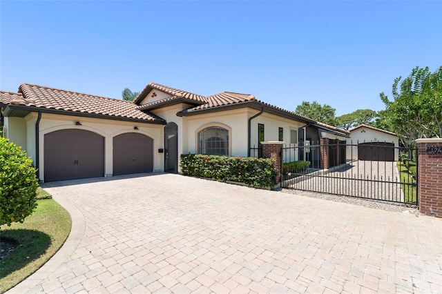 1741 Palmer Ave, Winter Park, FL 32789 - mediterranean / spanish home featuring an attached garage, stucco siding, driveway, a gate, and a tile roof