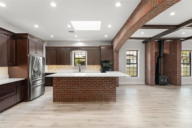 1741 Palmer Ave, Winter Park, FL 32789 - kitchen with black appliances, a skylight, a sink, light countertops, and recessed lighting