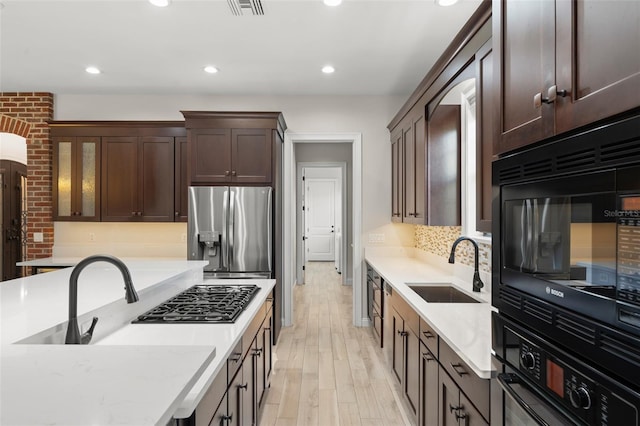 1741 Palmer Ave, Winter Park, FL 32789 - kitchen with black appliances, a sink, dark brown cabinetry, light wood-type flooring, and recessed lighting