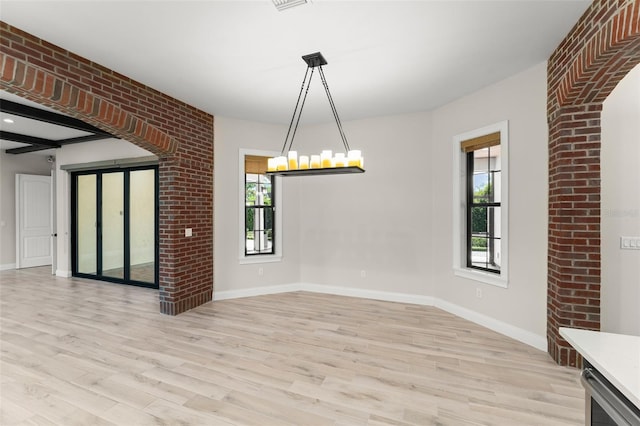 1741 Palmer Ave, Winter Park, FL 32789 - unfurnished dining area featuring light wood-style floors and baseboards