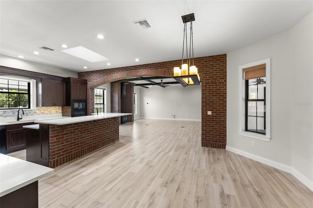 1741 Palmer Ave, Winter Park, FL 32789 - kitchen with a sink, light countertops, open floor plan, light wood-style floors, and recessed lighting