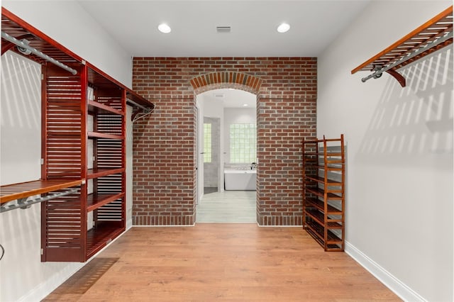 1741 Palmer Ave, Winter Park, FL 32789 - walk in closet featuring wood finished floors and arched walkways