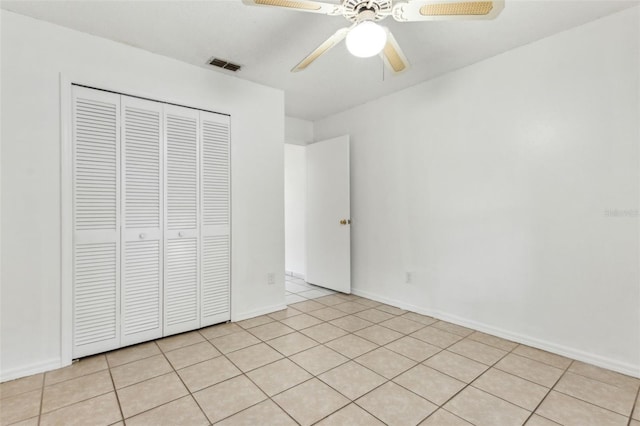 896 Satin Leaf Cir, Ocoee, FL 34761 - unfurnished bedroom with a closet, light tile patterned flooring, and a ceiling fan