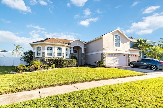 10642 Cloudview Dr, Orlando, FL 32825 - view of front facade featuring stone siding, stucco siding, a garage, and driveway
