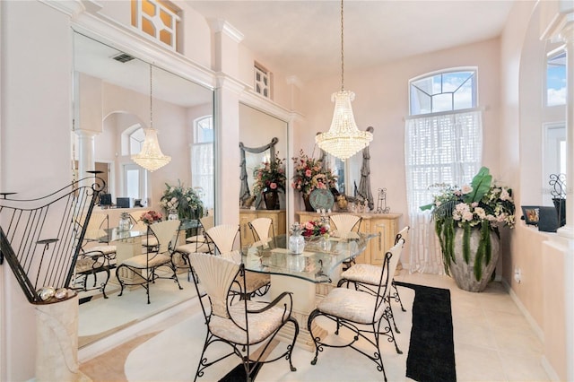 10642 Cloudview Dr, Orlando, FL 32825 - tiled dining area with arched walkways, a chandelier, and decorative columns