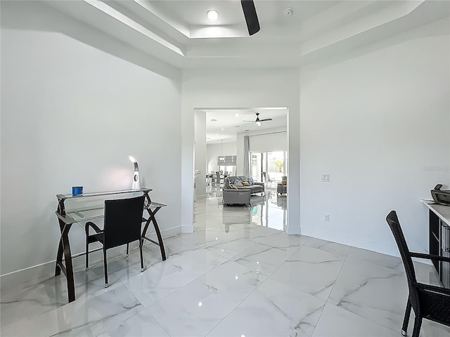 601 Green Briar Blvd, Altamonte Springs, FL 32714 - home office featuring a ceiling fan, a tray ceiling, light marble finish floors, and baseboards