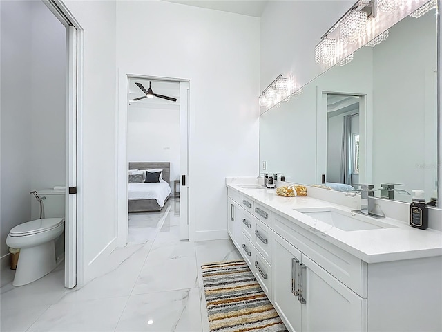601 Green Briar Blvd, Altamonte Springs, FL 32714 - full bath featuring marble look tile flooring, toilet, double vanity, connected bathroom, and ceiling fan