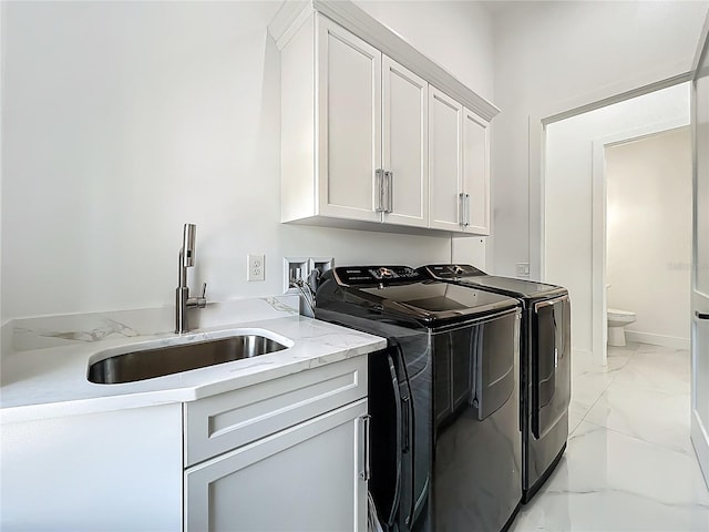 601 Green Briar Blvd, Altamonte Springs, FL 32714 - laundry room featuring separate washer and dryer, light marble finish floors, and cabinet space