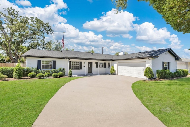 2460 Worthington Rd, Maitland, FL 32751 - ranch-style house featuring an attached garage, concrete driveway, stucco siding, and a chimney