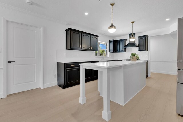 2460 Worthington Rd, Maitland, FL 32751 - kitchen featuring wall chimney exhaust hood, light countertops, a center island, a sink, and baseboards
