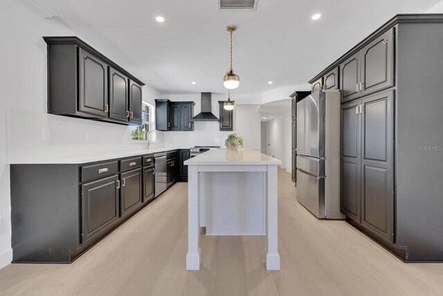 2460 Worthington Rd, Maitland, FL 32751 - kitchen featuring wall chimney range hood, stainless steel appliances, a kitchen island, light countertops, and recessed lighting