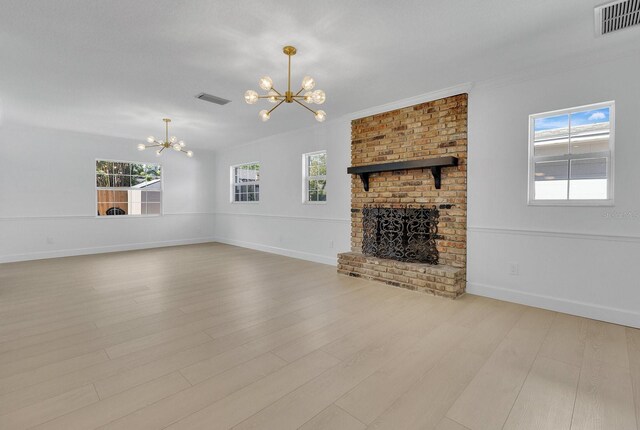 2460 Worthington Rd, Maitland, FL 32751 - unfurnished living room with a chandelier, wood finished floors, a brick fireplace, baseboards, and crown molding