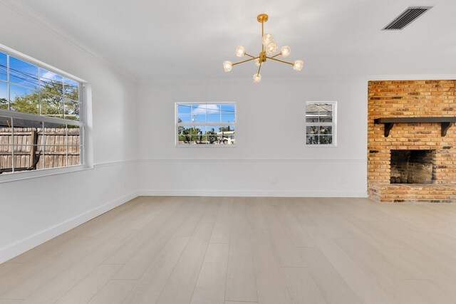 2460 Worthington Rd, Maitland, FL 32751 - unfurnished living room featuring a chandelier, ornamental molding, a fireplace, healthy amount of natural light, and wood finished floors