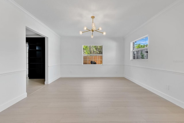 2460 Worthington Rd, Maitland, FL 32751 - unfurnished room featuring crown molding, a chandelier, healthy amount of natural light, and light wood finished floors