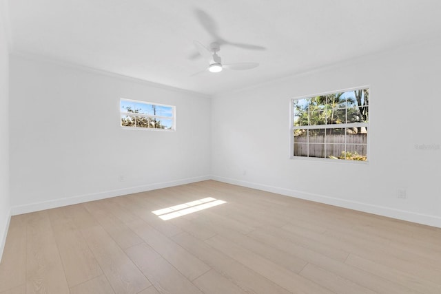 2460 Worthington Rd, Maitland, FL 32751 - spare room featuring light wood-type flooring, healthy amount of natural light, ceiling fan, and crown molding
