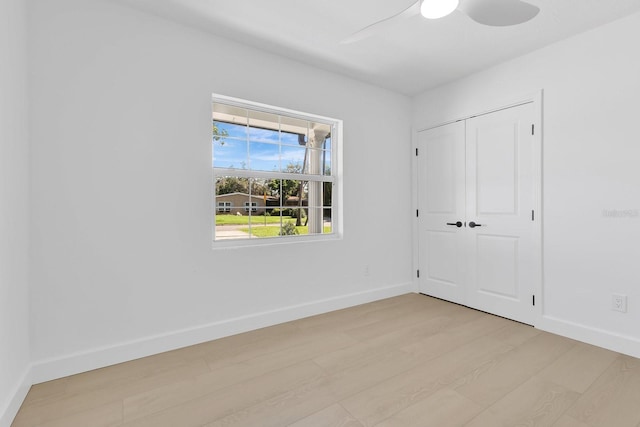2460 Worthington Rd, Maitland, FL 32751 - unfurnished bedroom featuring light wood-type flooring, baseboards, a closet, and ceiling fan