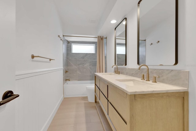 2460 Worthington Rd, Maitland, FL 32751 - full bathroom featuring shower / washtub combination, toilet, double vanity, and wainscoting