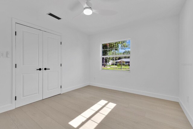 2460 Worthington Rd, Maitland, FL 32751 - unfurnished bedroom with wood finished floors, a closet, baseboards, and a ceiling fan