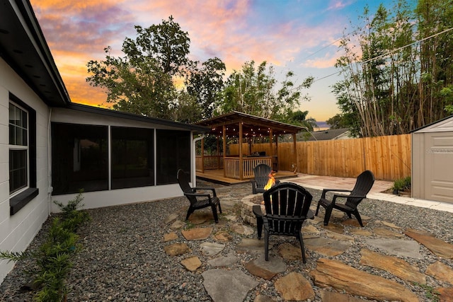 2460 Worthington Rd, Maitland, FL 32751 - fenced backyard with an outdoor fire pit, a sunroom, a patio, and a deck