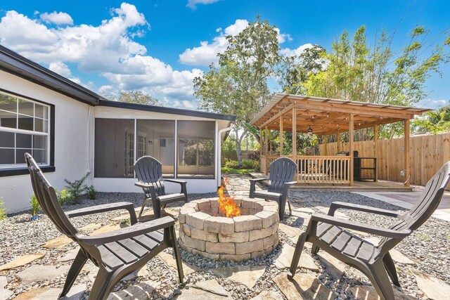 2460 Worthington Rd, Maitland, FL 32751 - view of patio / terrace with a fire pit and a sunroom