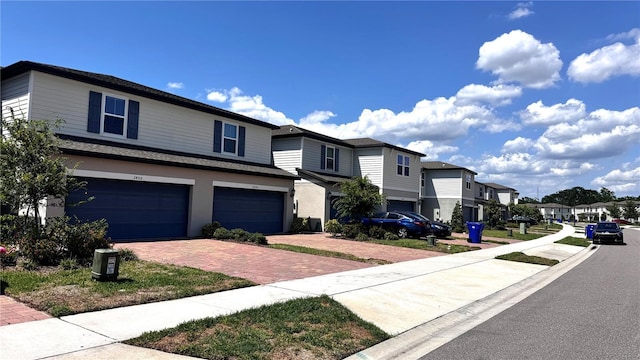 2450 Sweet Viburnum Way, Ocoee, FL 34761 - view of front facade with a residential view, decorative driveway, and a garage