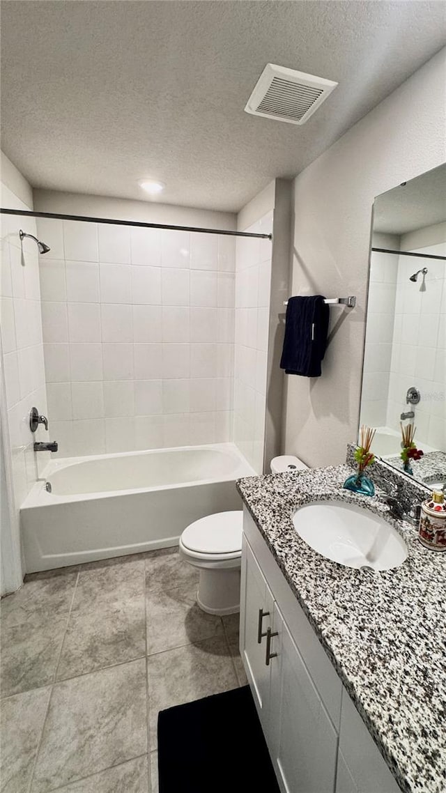 2450 Sweet Viburnum Way, Ocoee, FL 34761 - bathroom with vanity, a textured ceiling, toilet, shower / bathtub combination, and tile patterned flooring