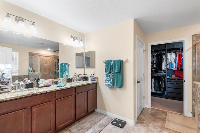 14095 Tropical Kingbird Way, Riverview, FL 33579 - full bath featuring a shower stall, double vanity, tile patterned flooring, a spacious closet, and baseboards