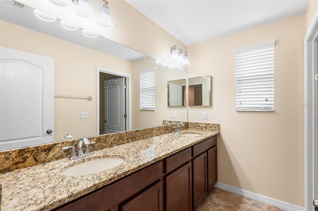 14095 Tropical Kingbird Way, Riverview, FL 33579 - bathroom with baseboards, double vanity, and tile patterned floors