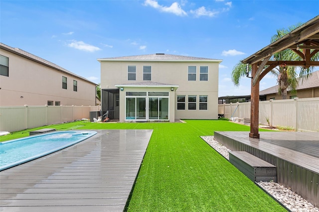 14095 Tropical Kingbird Way, Riverview, FL 33579 - back of property featuring stucco siding, a sunroom, a wooden deck, and central AC