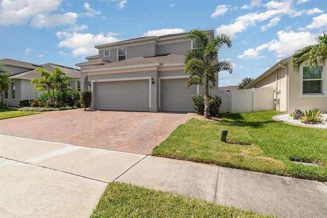 2061 Rush Bay Way, Orlando, FL 32824 - view of front facade with stucco siding, decorative driveway, an attached garage, and a shingled roof