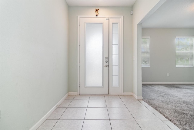 2061 Rush Bay Way, Orlando, FL 32824 - entrance foyer featuring light tile patterned flooring and light colored carpet