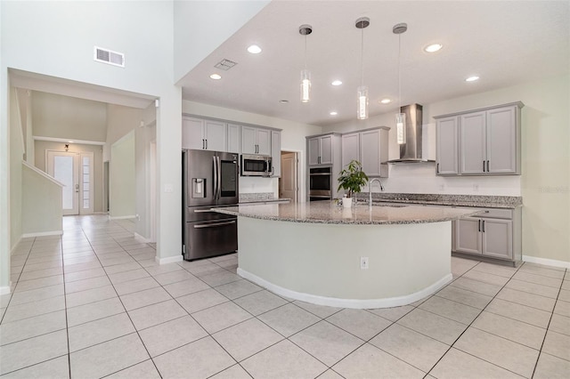 2061 Rush Bay Way, Orlando, FL 32824 - kitchen featuring wall chimney range hood, stainless steel appliances, gray cabinetry, light tile patterned floors, and light stone countertops