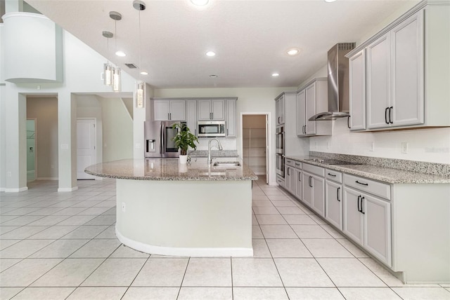 2061 Rush Bay Way, Orlando, FL 32824 - kitchen with stainless steel appliances, wall chimney exhaust hood, light tile patterned floors, recessed lighting, and light stone counters
