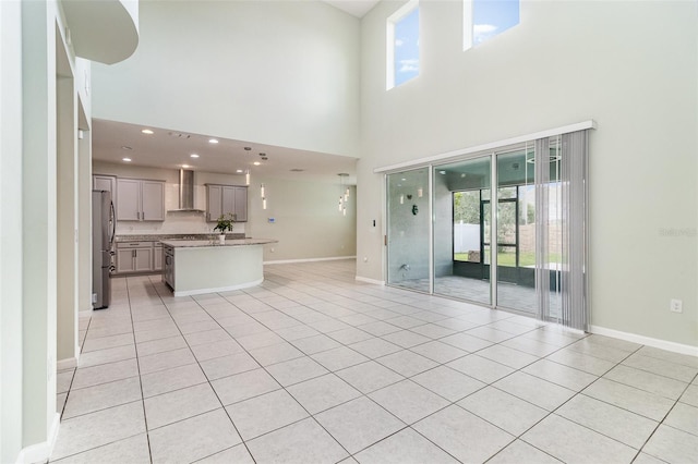 2061 Rush Bay Way, Orlando, FL 32824 - unfurnished living room with a towering ceiling, light tile patterned flooring, and recessed lighting